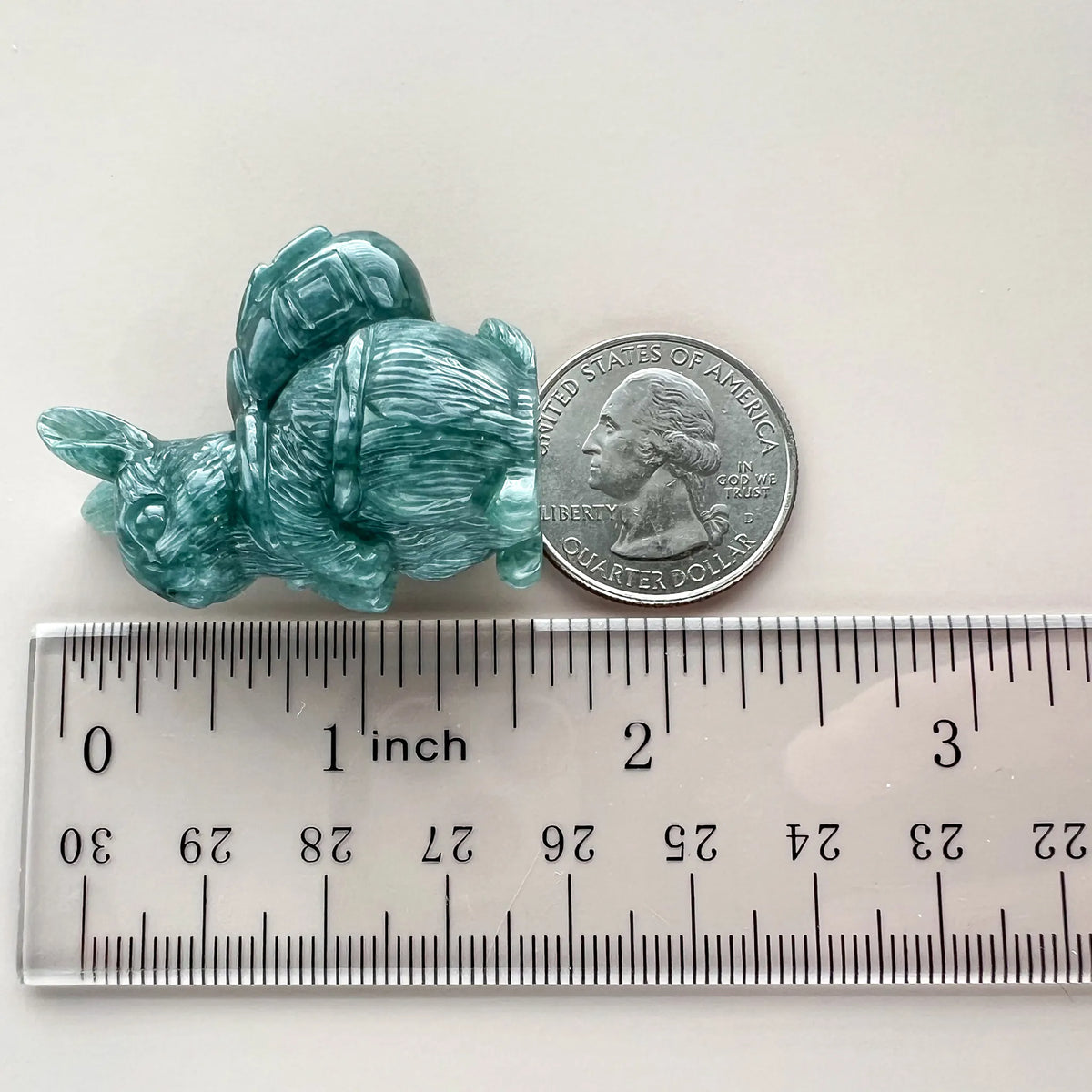 Green jadeite rabbit sculpture with fortune pouch, 3D hand-carved, glossy translucent finish, shown with coin and ruler for s