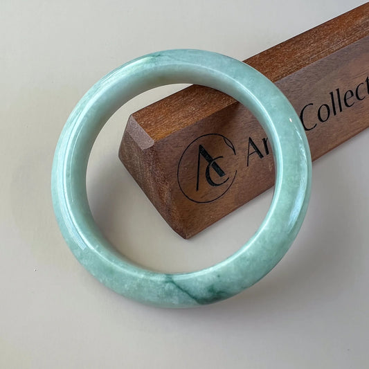 Aria Collection smooth round natural jade bangle in light blue-green with glossy polished finish