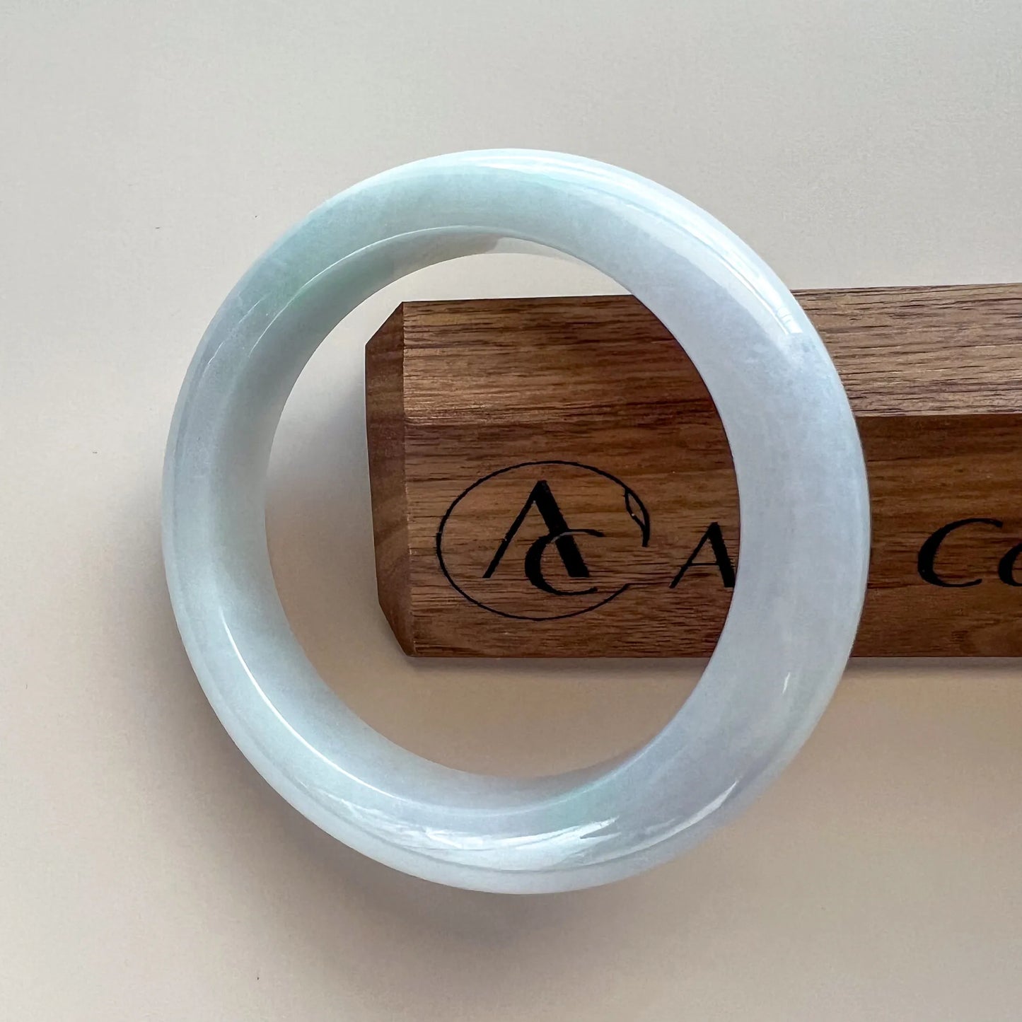 Aria Design Collection icy light blue jadeite bangle with a smooth rounded profile and polished finish