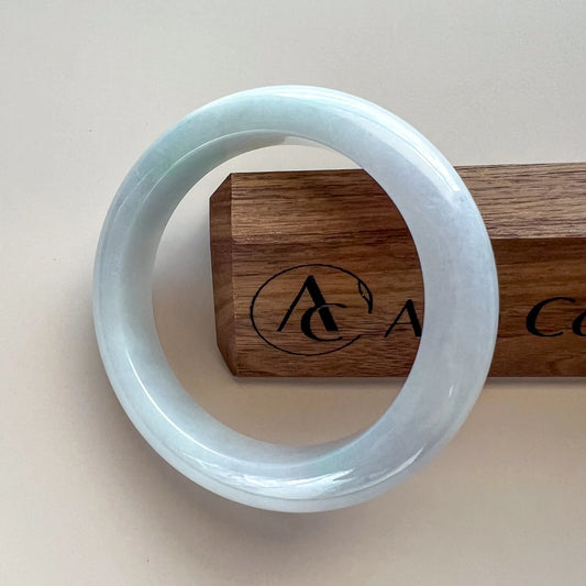 Aria Design Collection icy light blue jadeite bangle with a smooth rounded profile and polished finish