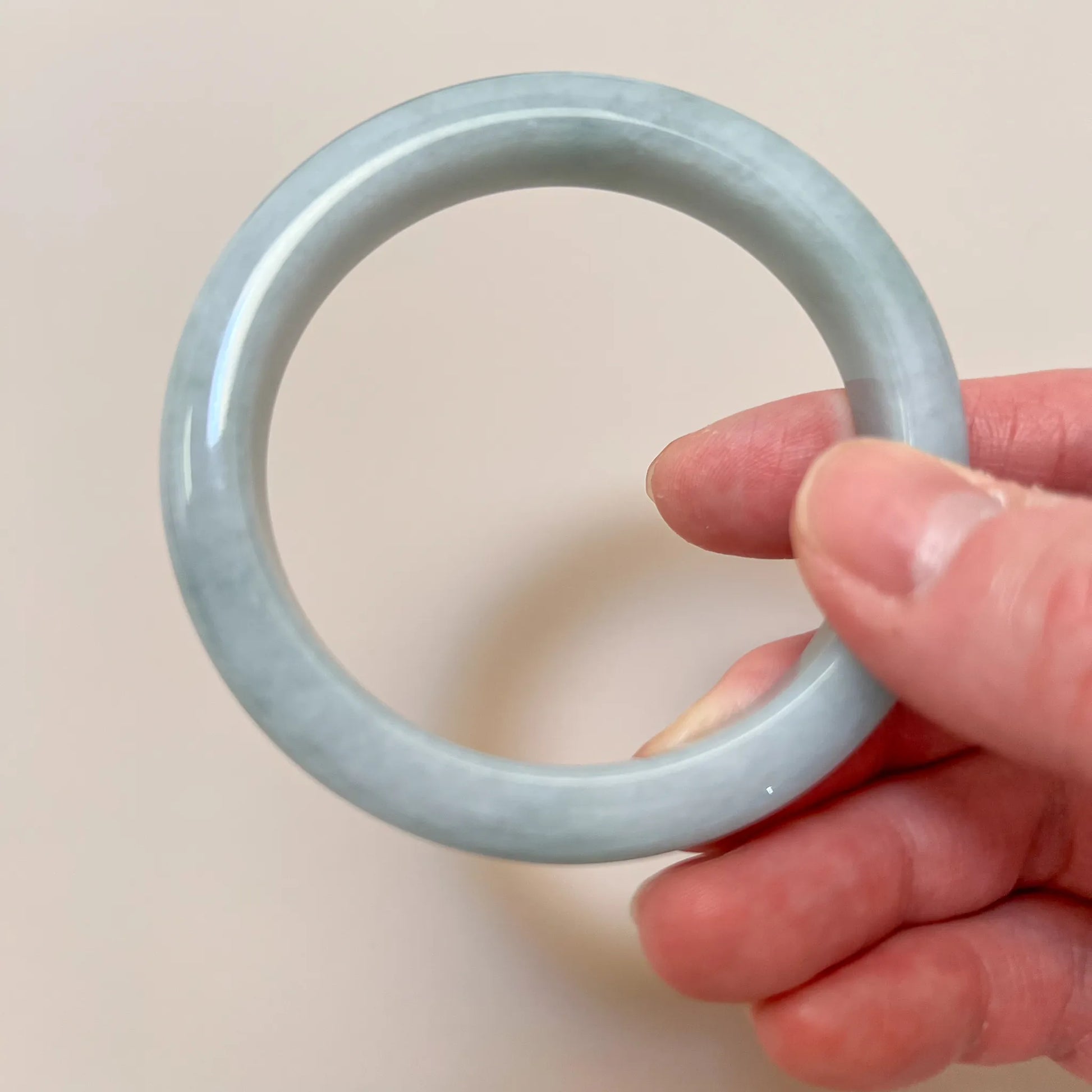 Front view of circular jade bangle with polished semi-translucent finish