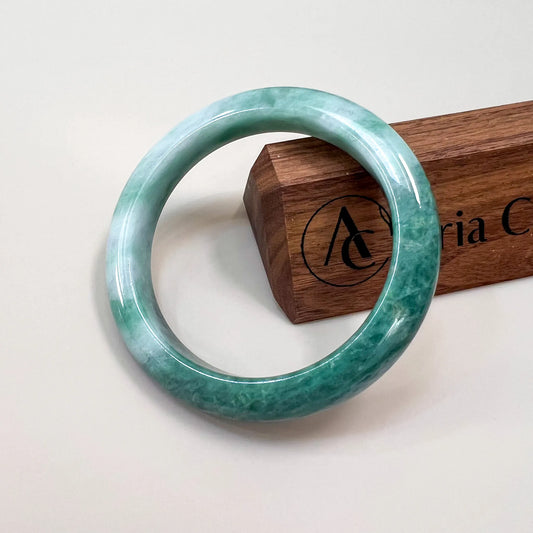 Aria Design Collection mottled green jadeite bangle with a smooth rounded profile and polished finish