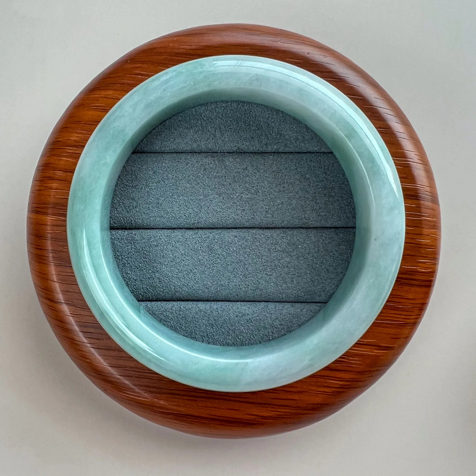 Top view of the jadeite bangle showing its smooth inner surface, rounded form, and glossy finish