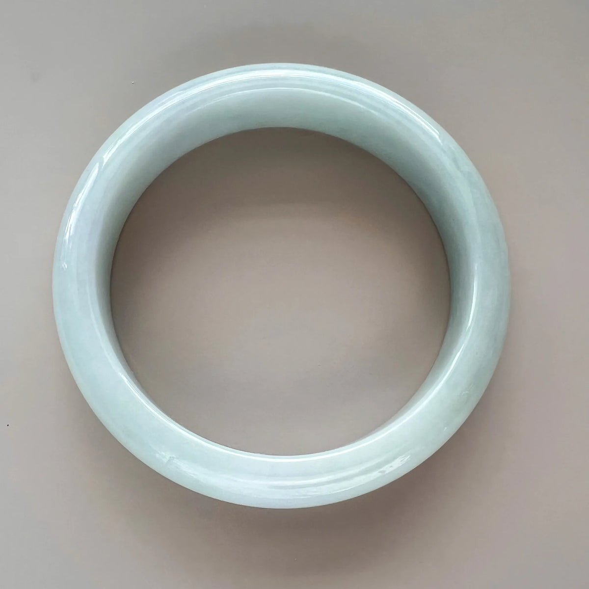 Aria Design Collection icy green-blue jadeite bangle with a smooth rounded profile and polished finish
