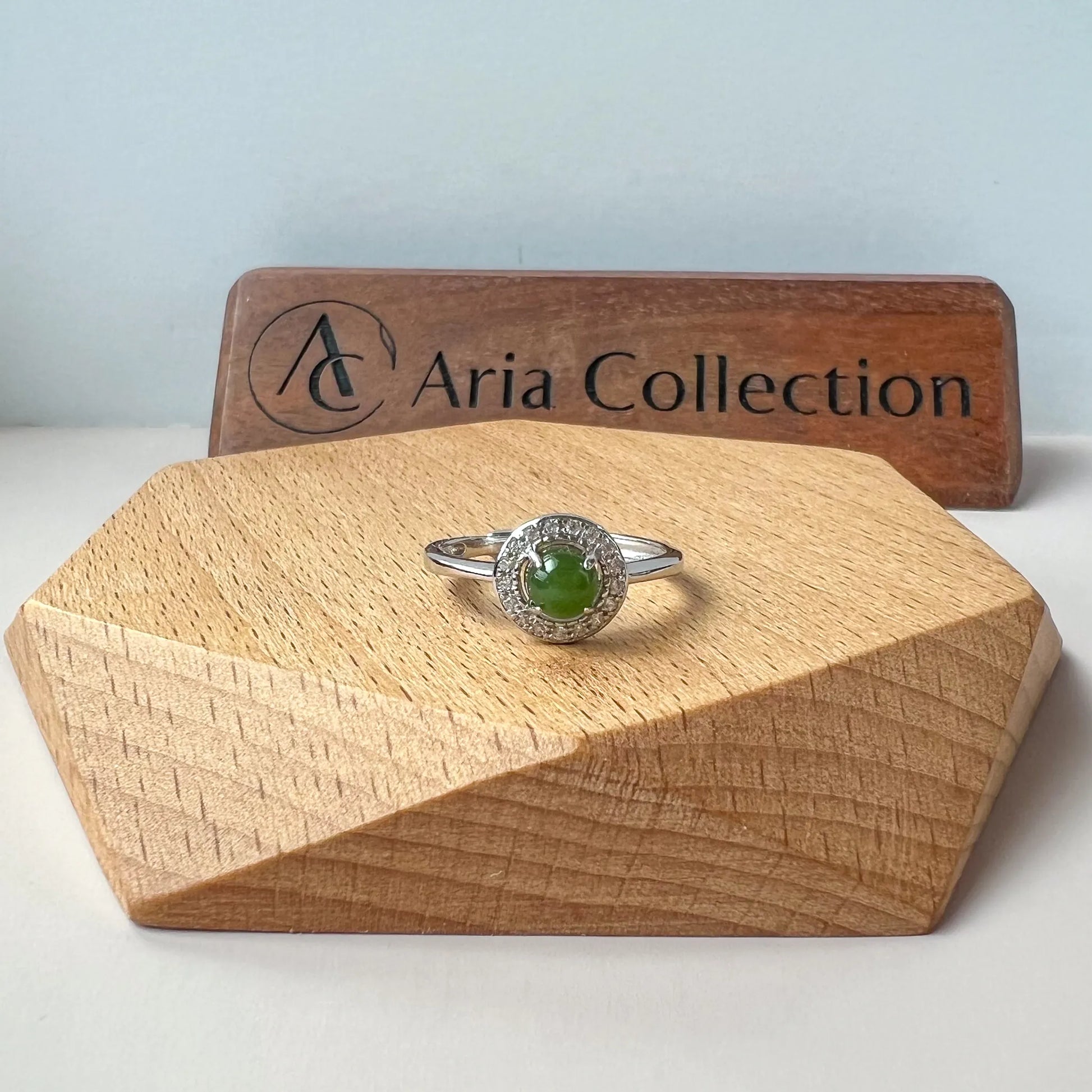 Aria Collection green natural jade cabochon ring with polished finish and sparkling halo