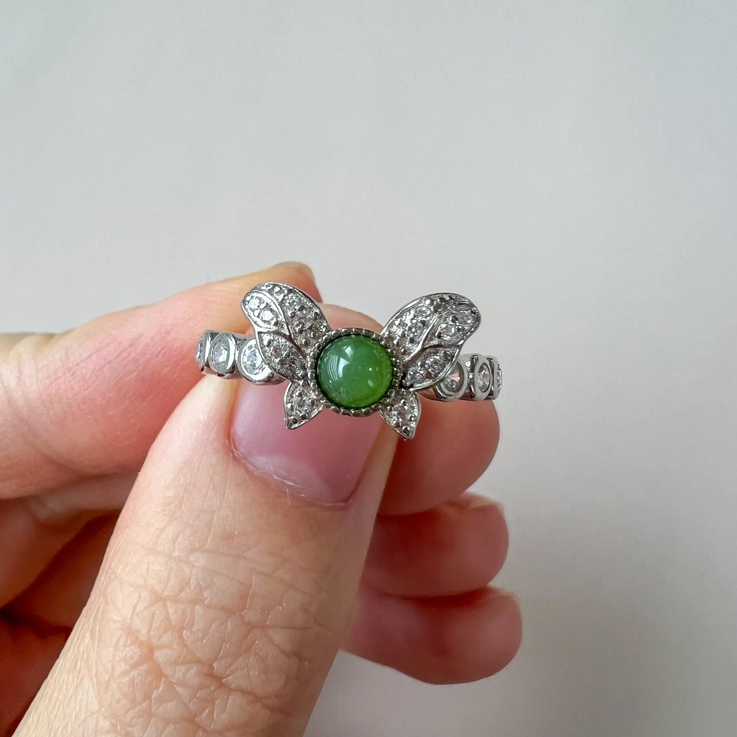 Aria Collection green natural jade cabochon butterfly ring with polished pavé white-metal finish