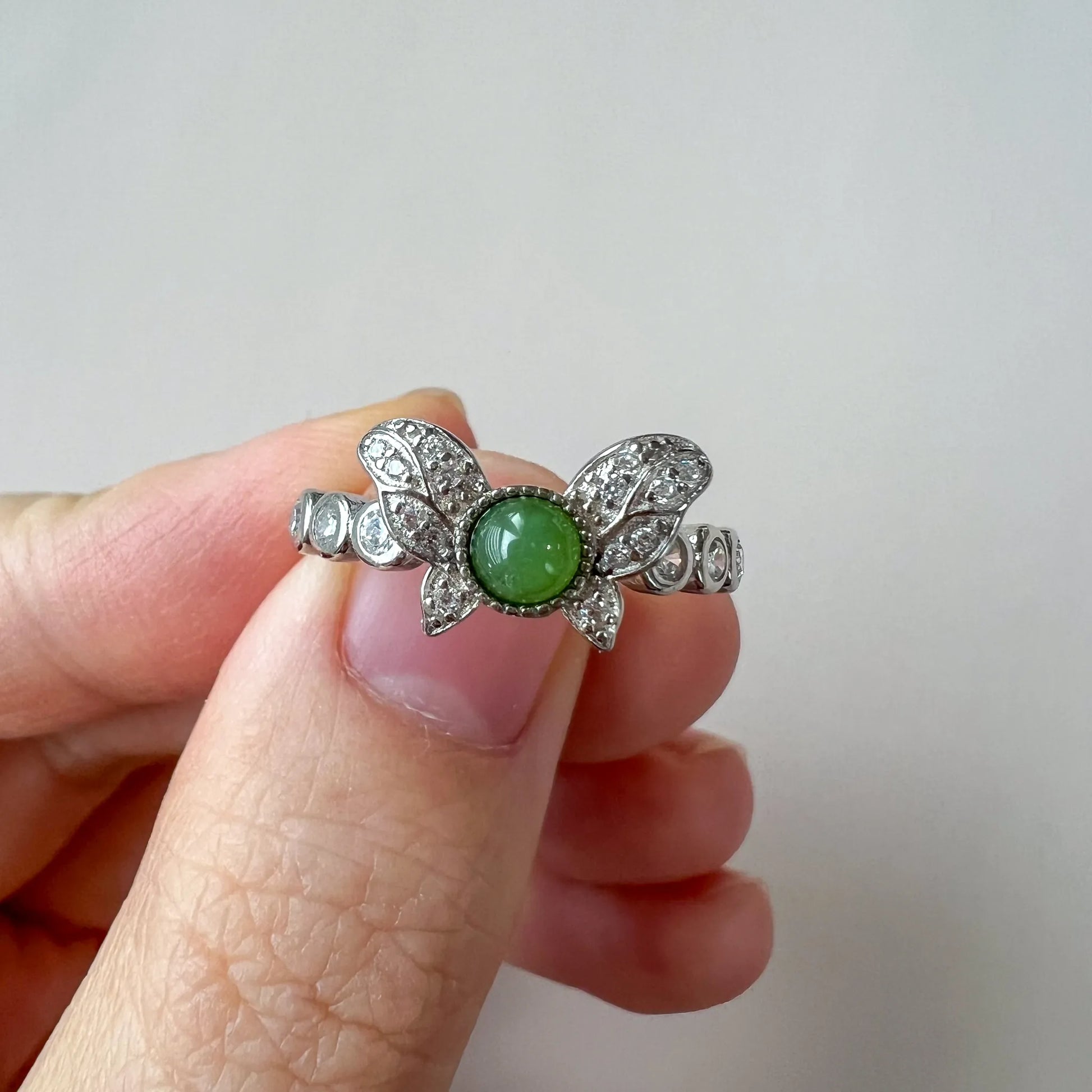 Aria Collection green natural jade cabochon butterfly ring with polished pavé white-metal finish