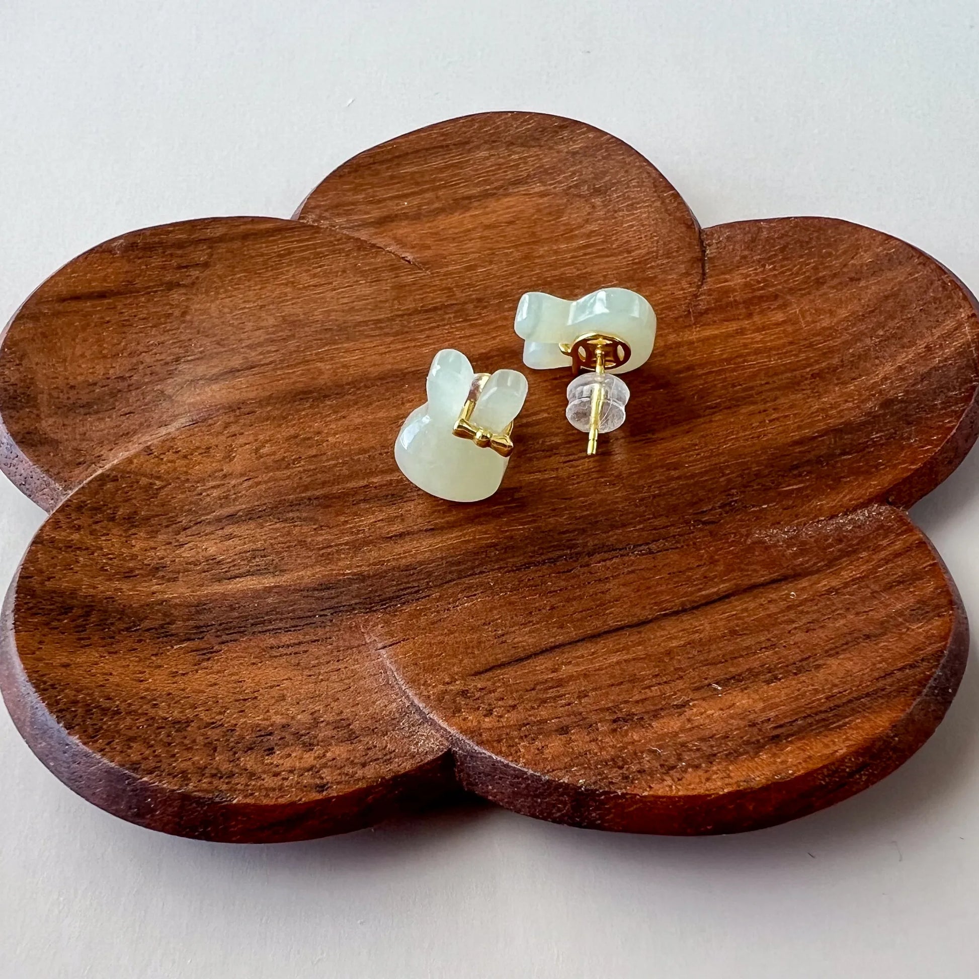 Side view of bunny stud earrings showing gold-tone posts and clear silicone backings