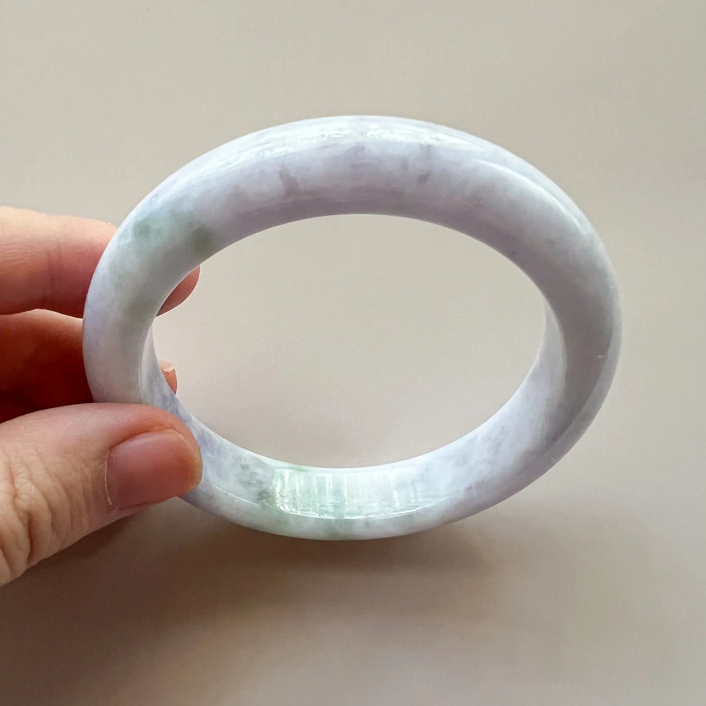 Inner and side profile of the semi-translucent lavender-green jadeite bangle with a smooth polish