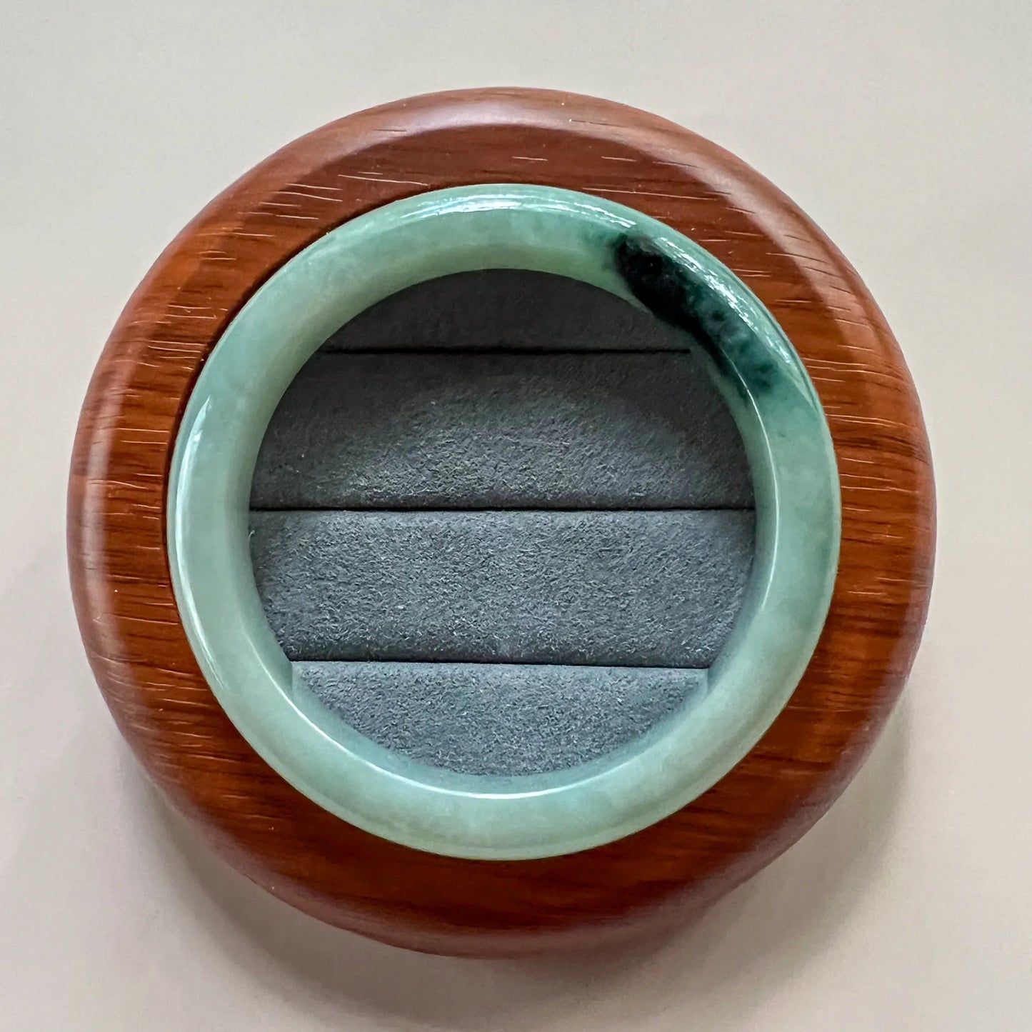 Aria Design Collection light green jadeite bangle, uncarved classic form with dark green patch and polished finish