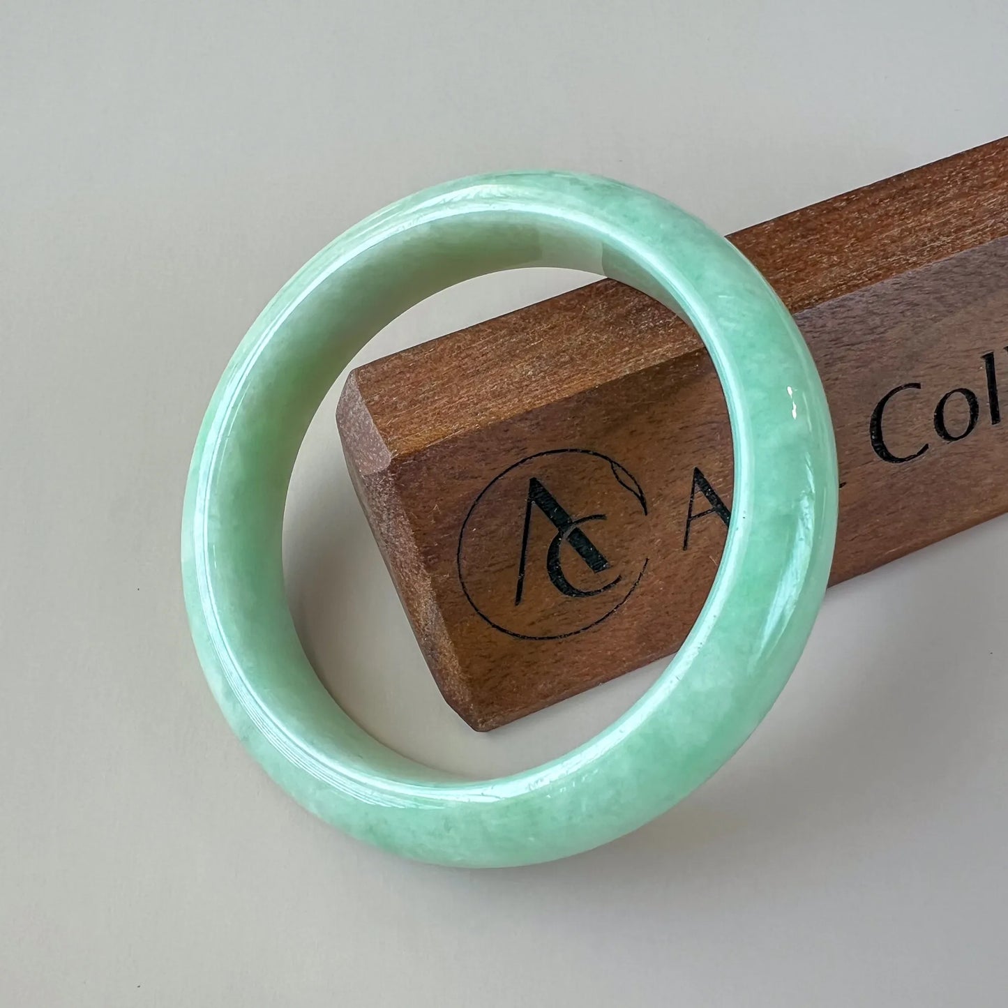 Aria Collection light green natural jade bangle, smooth rounded front with glossy polished finish