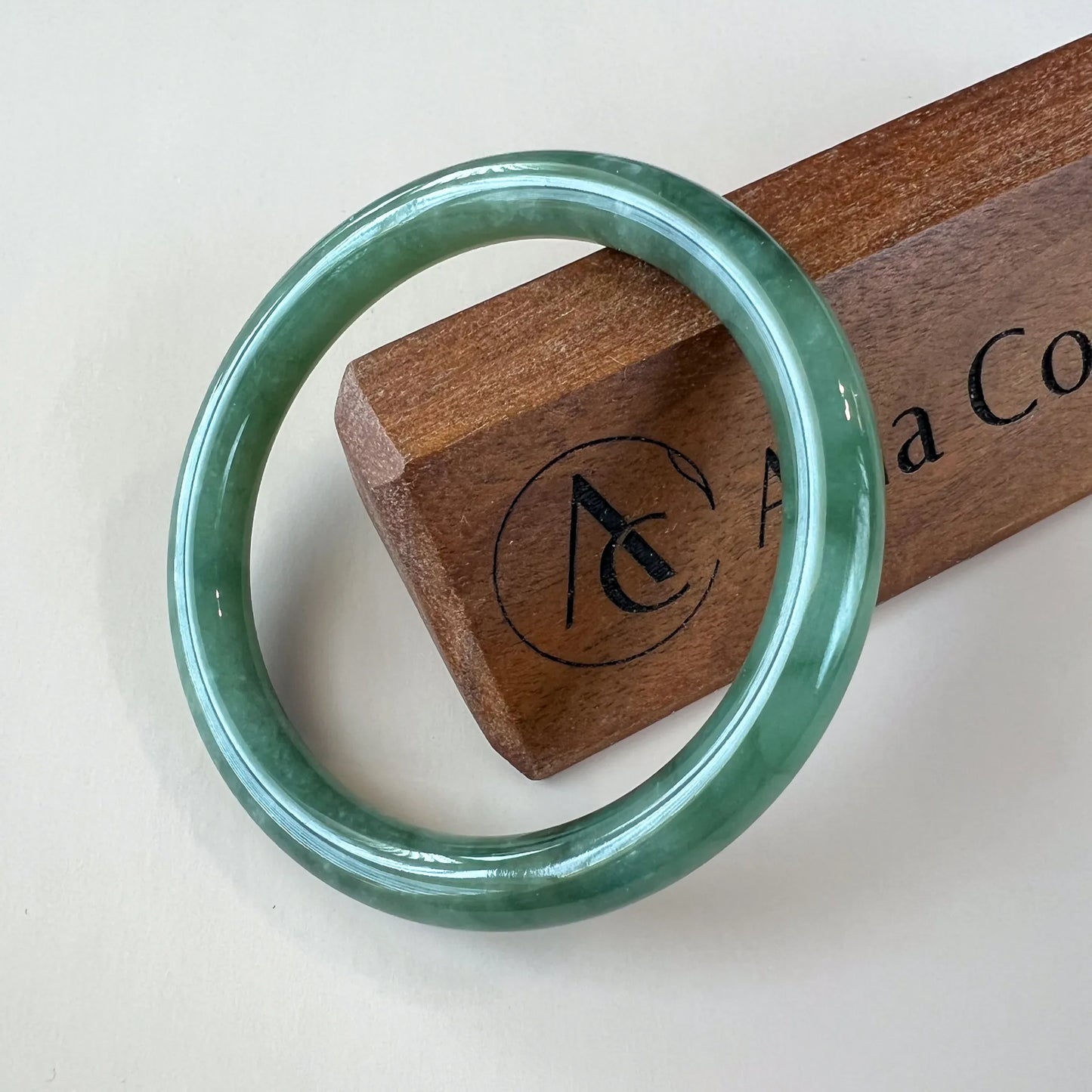 Aria Design Collection classic green jadeite bangle with a smooth round profile and high-polish finish