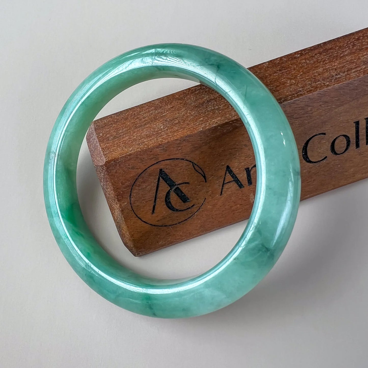 Aria Design Collection light green-blue jadeite bangle with a smooth rounded profile and polished finish