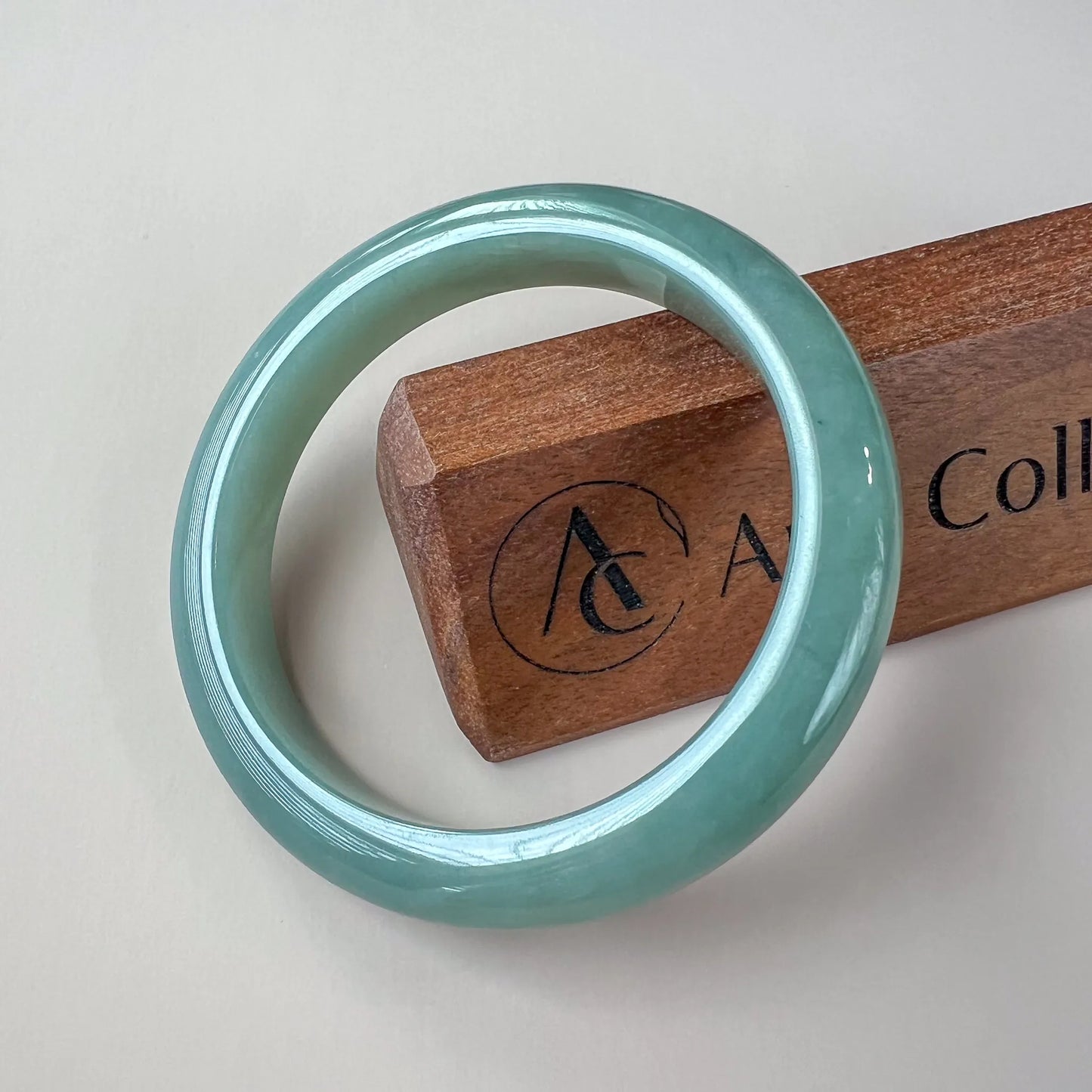Aria Design Collection light green-blue jadeite bangle with a classic rounded profile and glossy finish