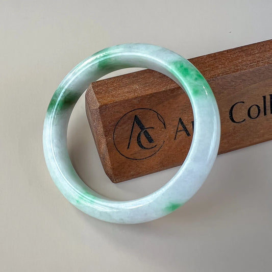 Aria Design Collection uncarved icy white and green jadeite bangle with a polished finish
