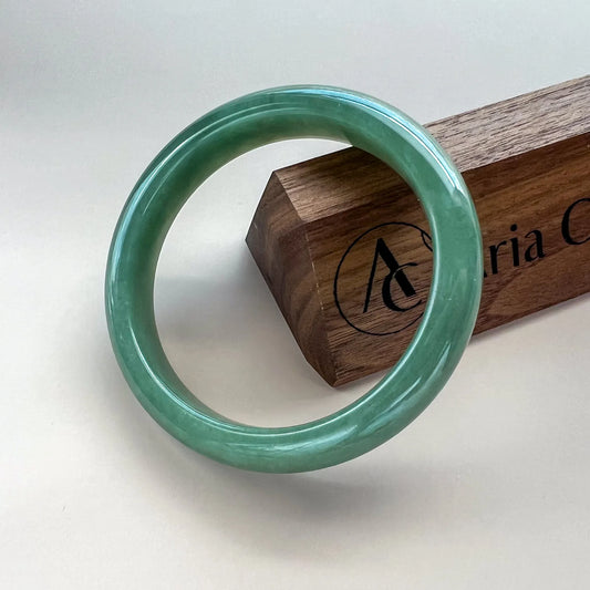 Aria Design Collection classic green jadeite bangle with a rounded profile and glossy polished finish