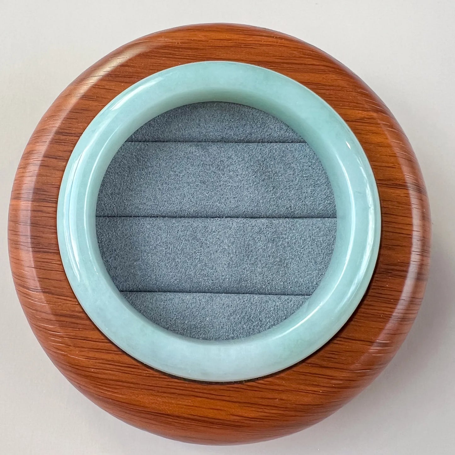Light blue Natural Jade bangle shown flat, highlighting smooth inner surface and high polish