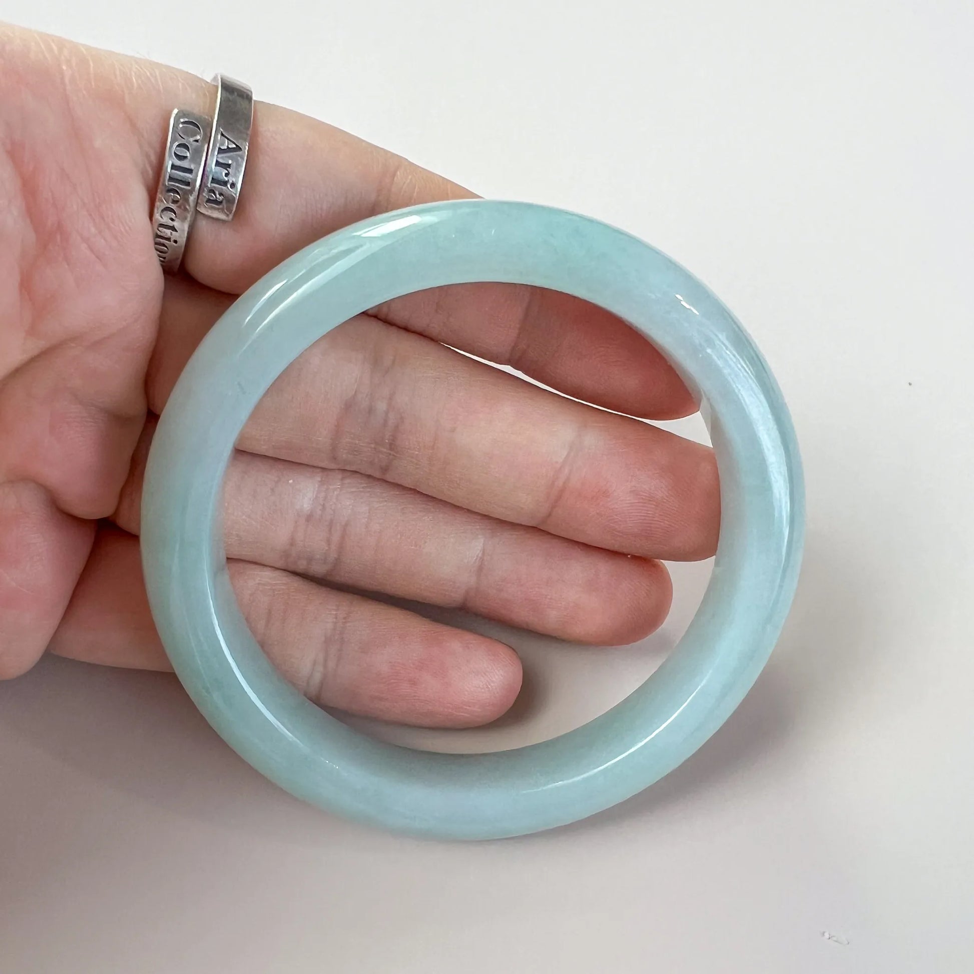 Aria Collection plain light blue Natural Jade bangle with rounded profile and glossy polished finish