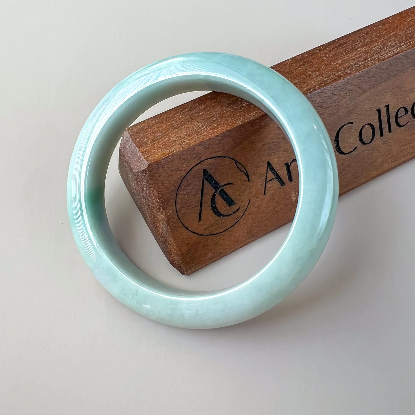 Aria Collection light blue natural jade bangle, plain rounded front with glossy polished finish