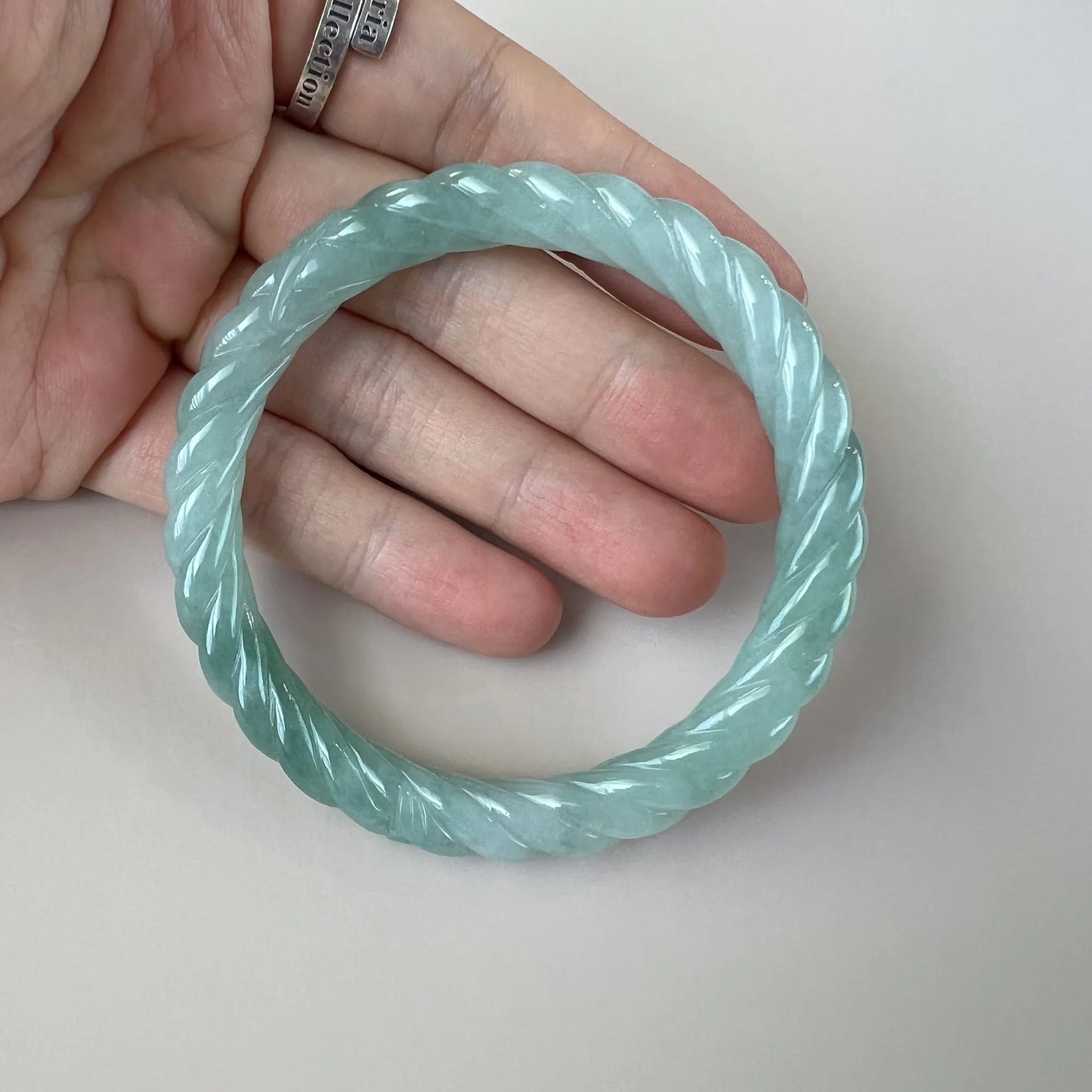 Aria Collection light blue natural jade bangle with twisted rope carving and glossy polished finish
