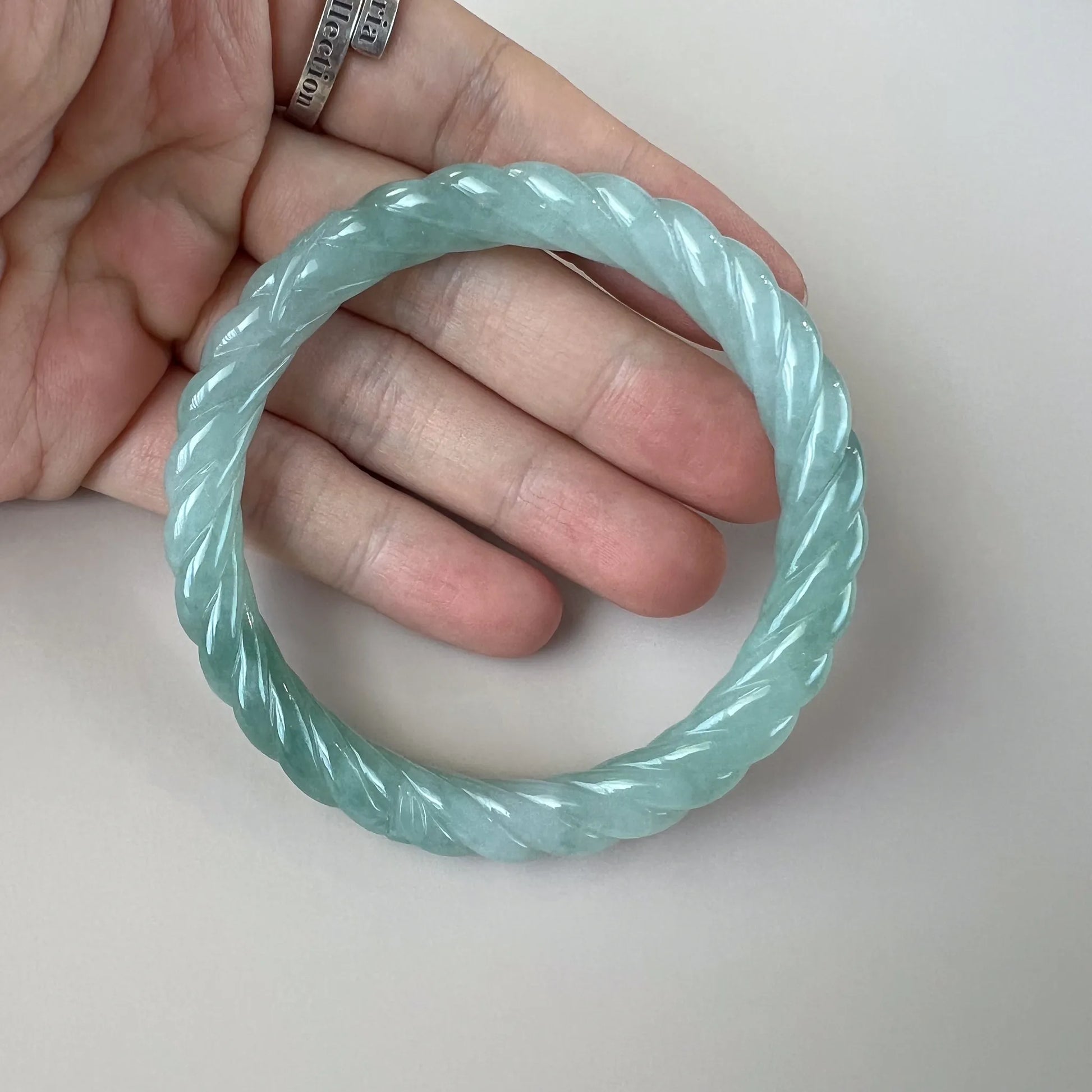 Aria Collection light blue natural jade bangle with twisted rope carving and glossy polished finish