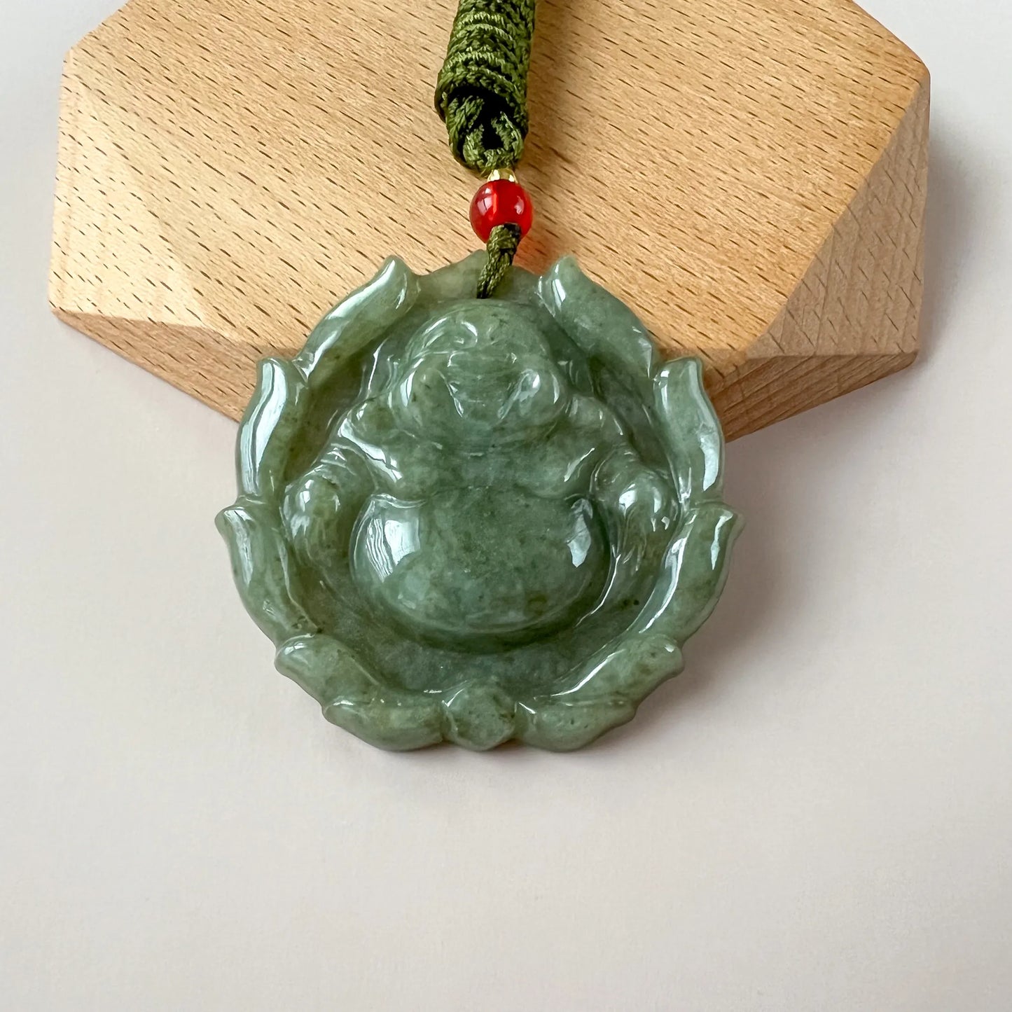 Aria Collection green jadeite jade Happy Buddha with lotus pendant, carved glossy style, beaded cord detail