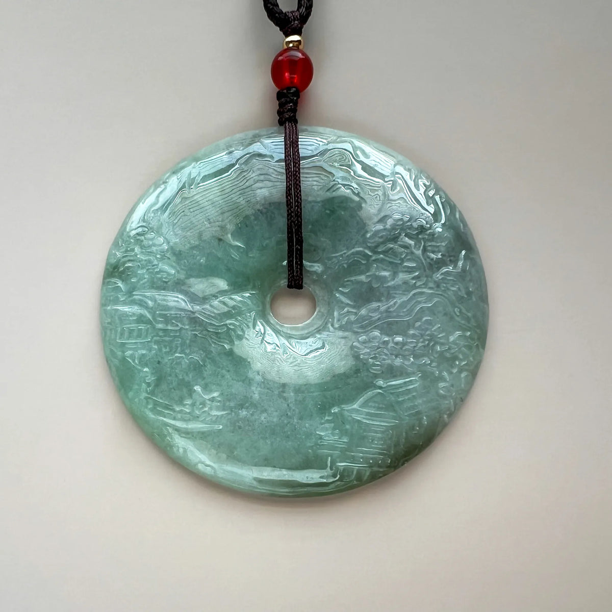 Aria Design Collection pale green natural jade pendant with landscape relief carving and polished finish