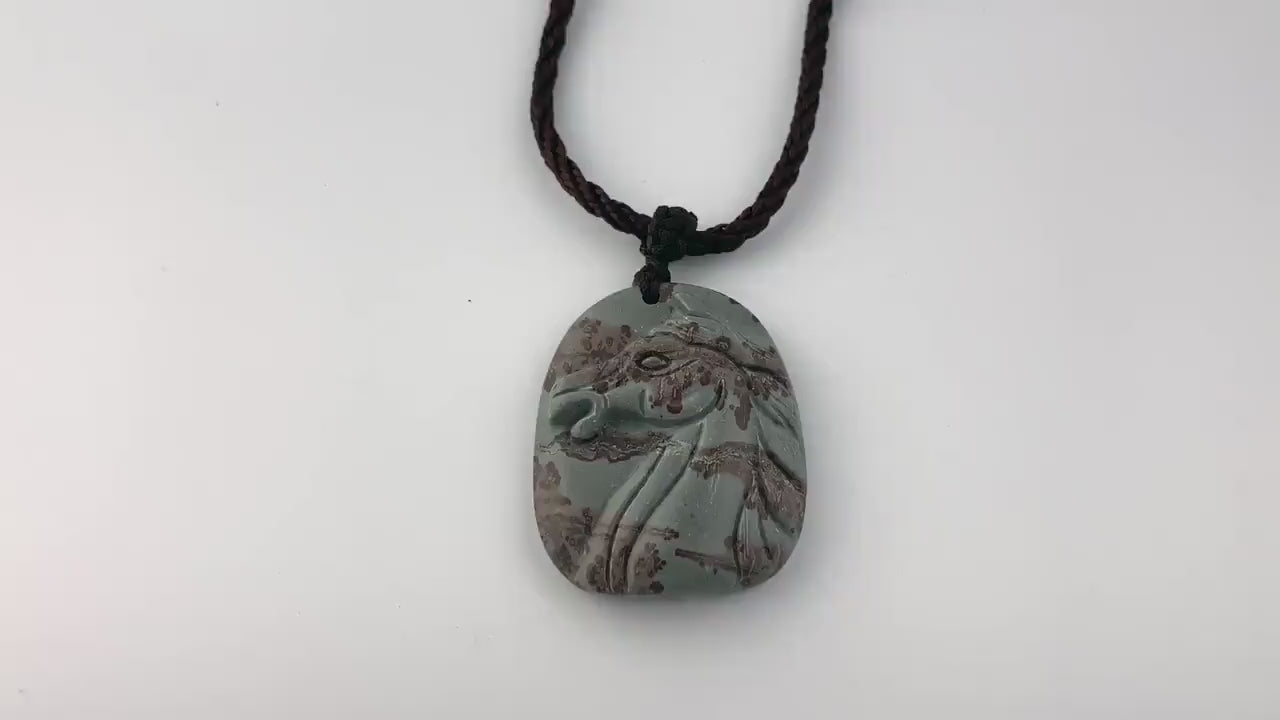 Video of a hand-carved natural jasper horse pendant in red and gray with detailed sculptural style