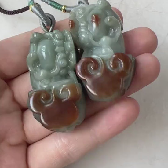 Video of matching hand-carved natural jadeite Pi Xiu pendants in red and green jade tones, elegant and detailed