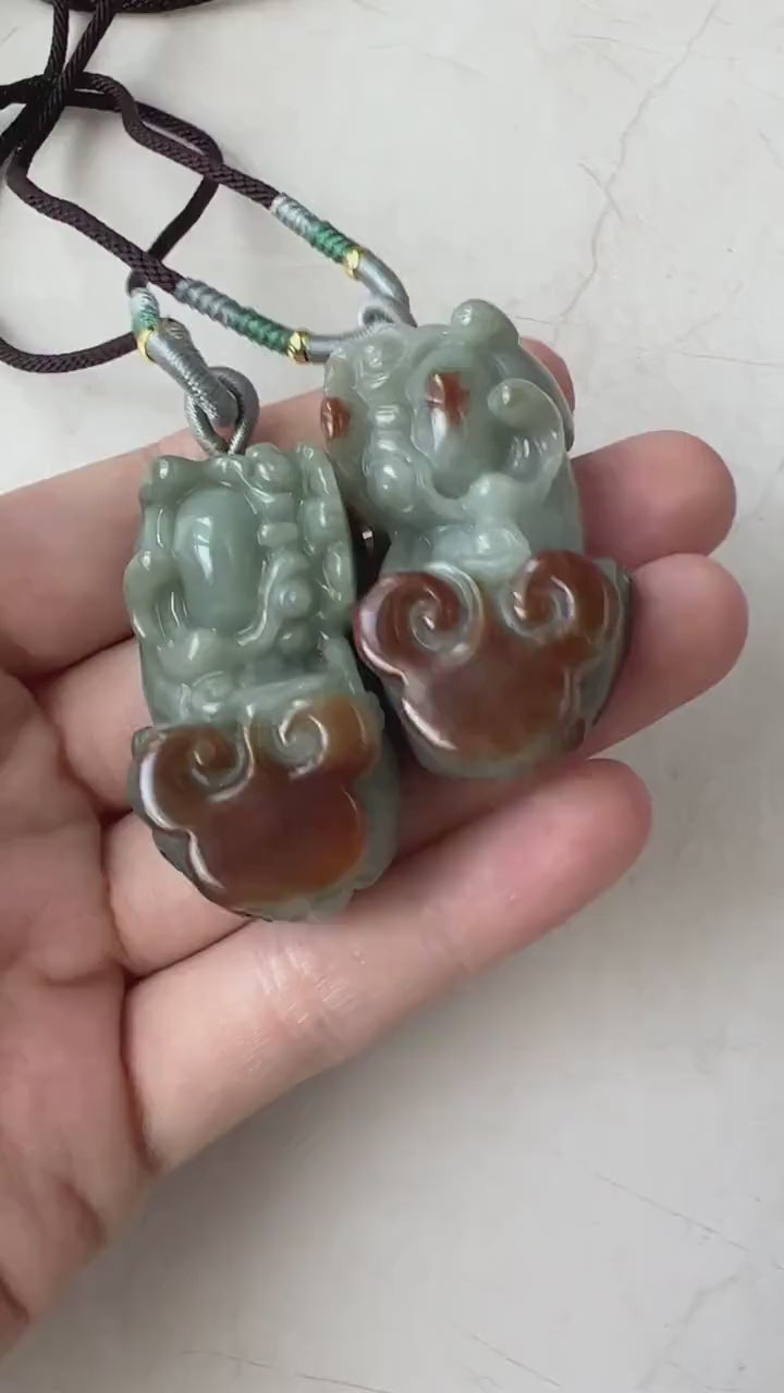 Video of matching hand-carved natural jadeite Pi Xiu pendants in red and green jade tones, elegant and detailed