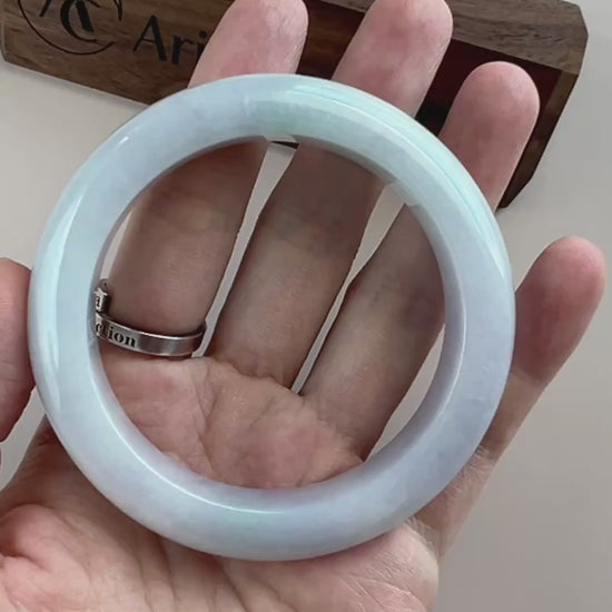 Video of an icy light blue Burmese jadeite bangle with smooth polished surface and rounded classic profile