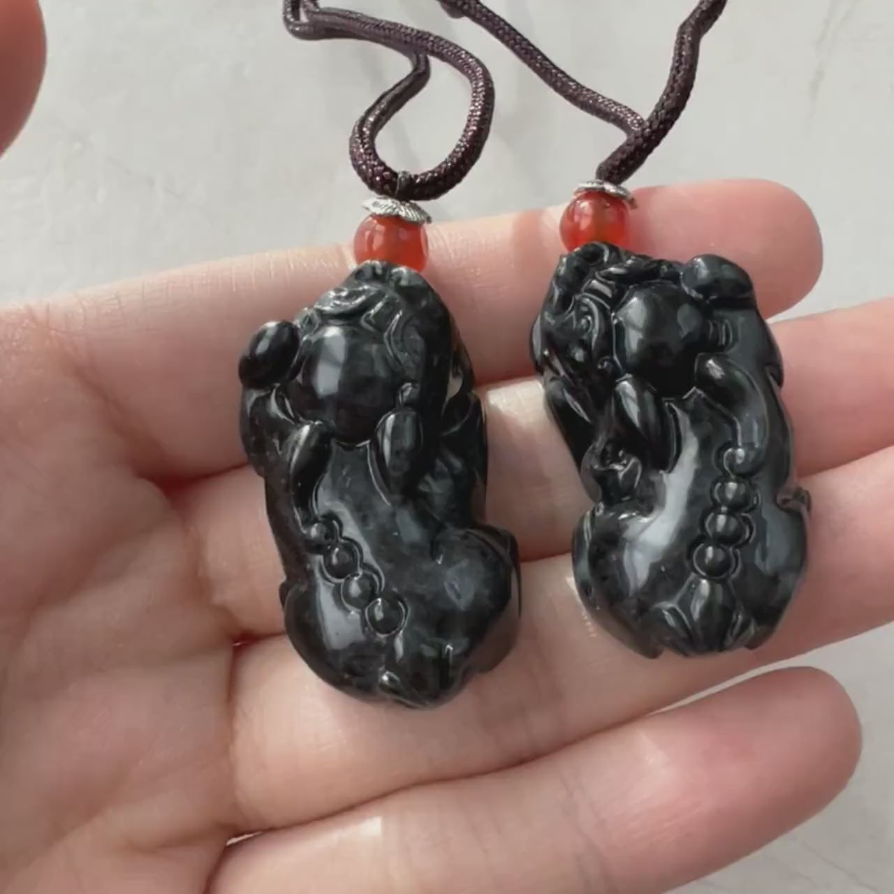 Video of a one-of-a-kind natural jade pendant with hand-carved dual Pi Xiu in an intricate, meaningful design