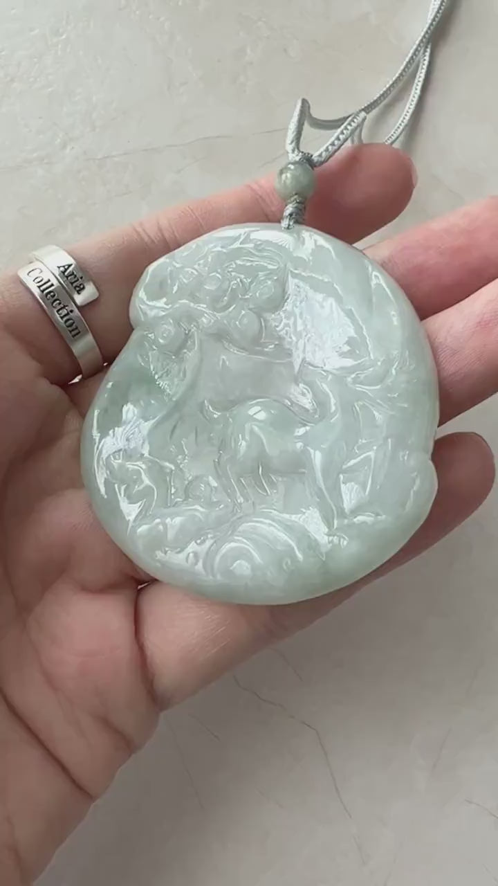 Video of a hand-carved green jadeite deer pendant with an elegant, organic forest scene design