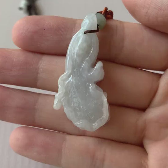Video of a hand-carved white translucent jadeite cabbage pendant with intricate detailing and natural elegance