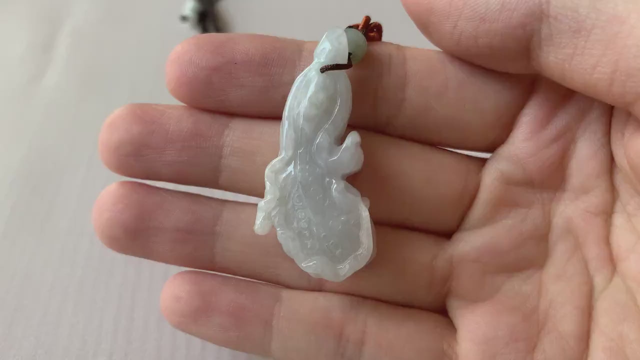 Video of a hand-carved white translucent jadeite cabbage pendant with intricate detailing and natural elegance