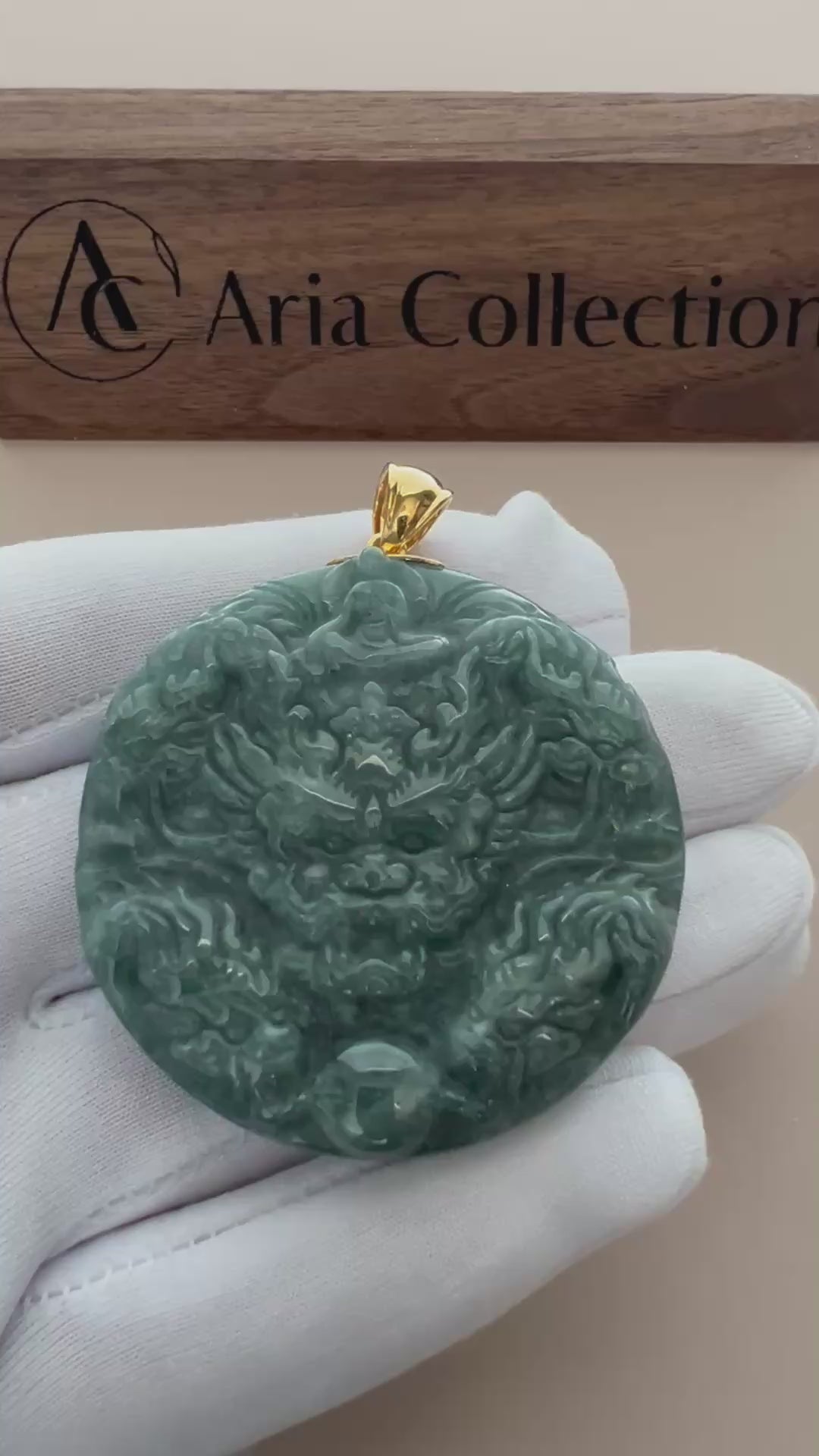 Video of a hand-carved jade pendant with nine dragons and faceless Buddha, accented by an 18K yellow gold bail