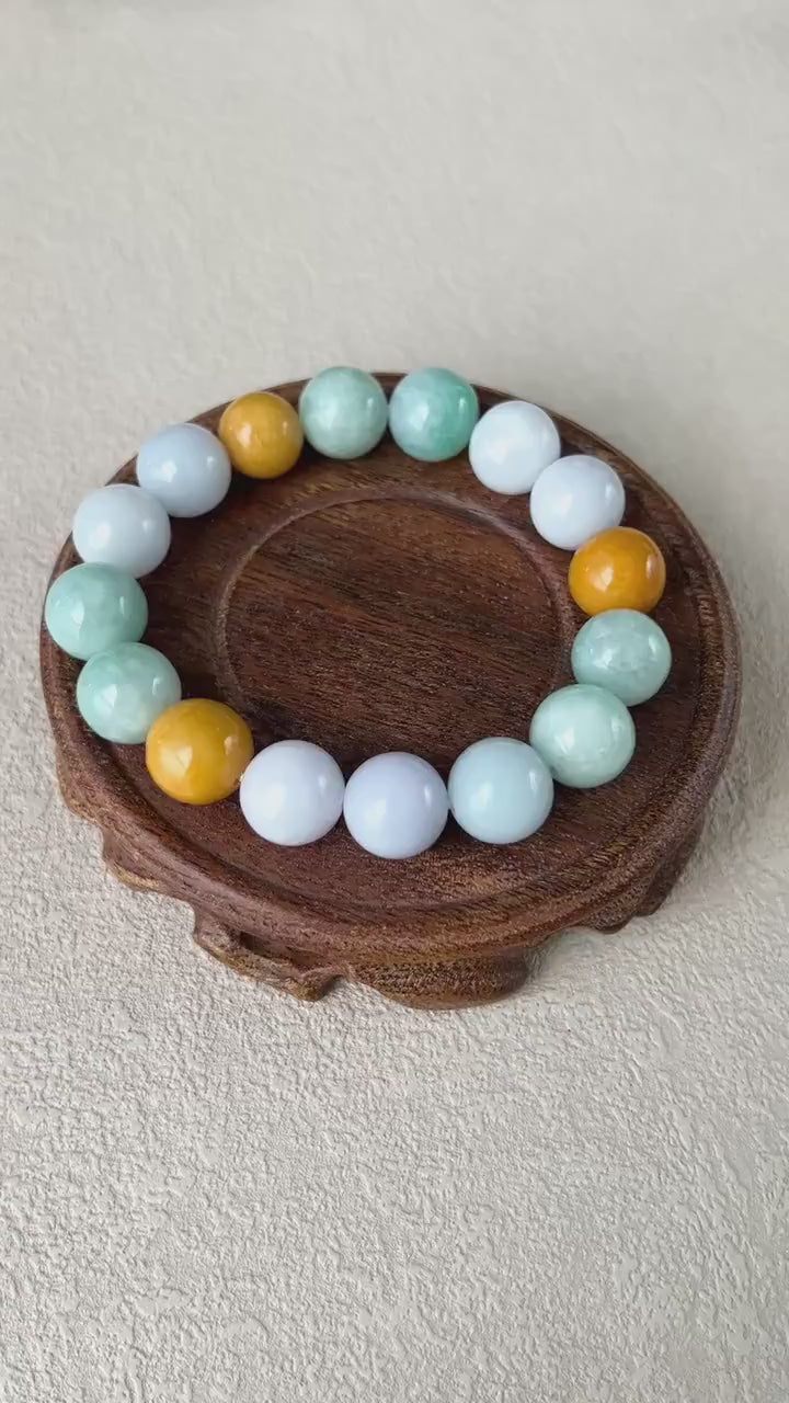Video of hand-carved jadeite bracelet with 16 semi-translucent lavender, green, and yellow beads in an elegant style