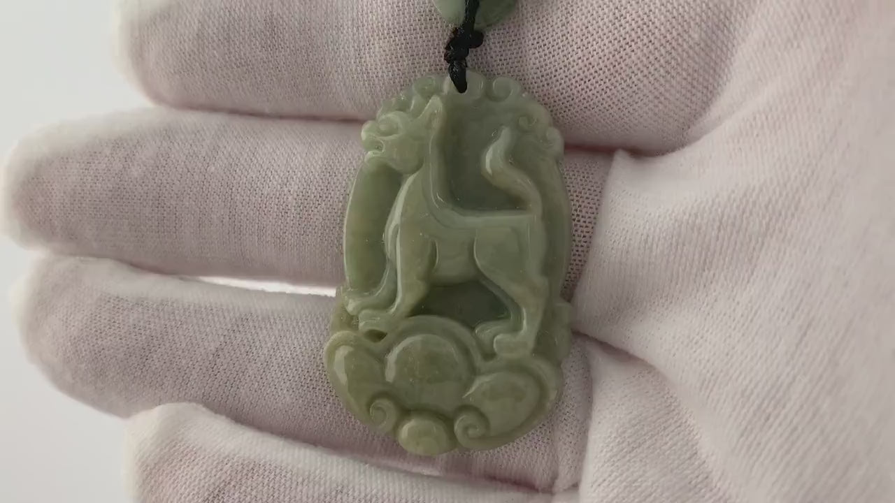 Video of a hand-carved natural jade Chinese Zodiac Dog pendant with unique green tones and artisanal detail