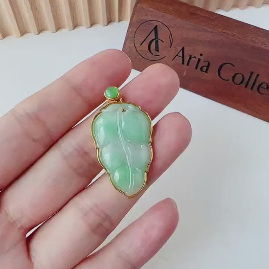 Video of a hand-carved green jade leaf pendant in a solid 18K gold frame, elegant and timeless