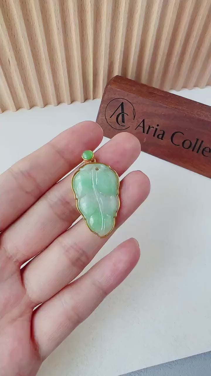 Video of a hand-carved green jade leaf pendant in a solid 18K gold frame, elegant and timeless