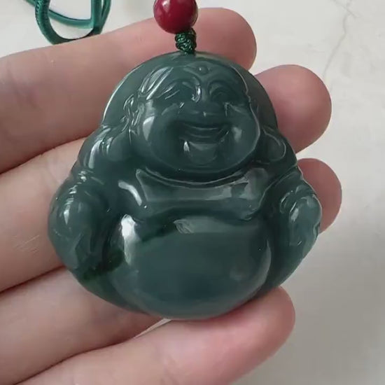 Video of a carved jade Laughing Buddha pendant in blue-green with a bright green streak and soft translucent glow