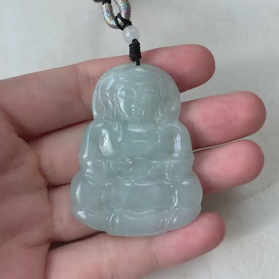Video of a hand-carved green jade Guan Yin pendant with intricate lotus details and serene, elegant style