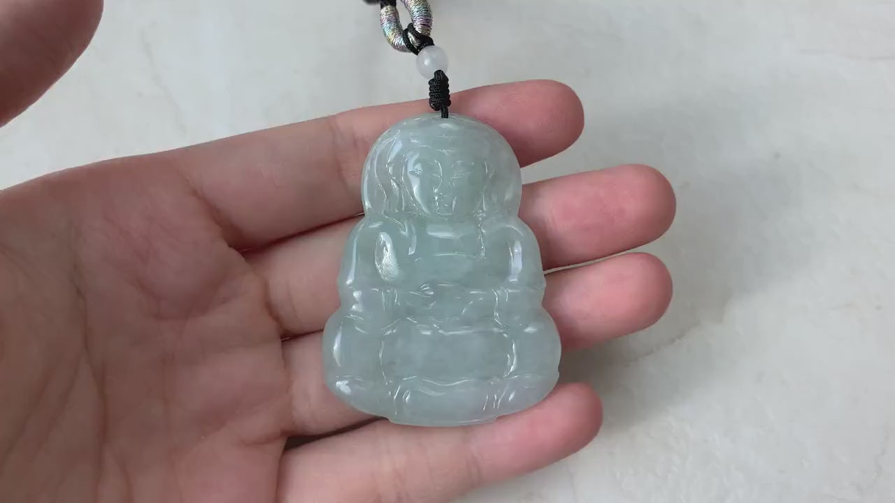Video of a hand-carved green jade Guan Yin pendant with intricate lotus details and serene, elegant style