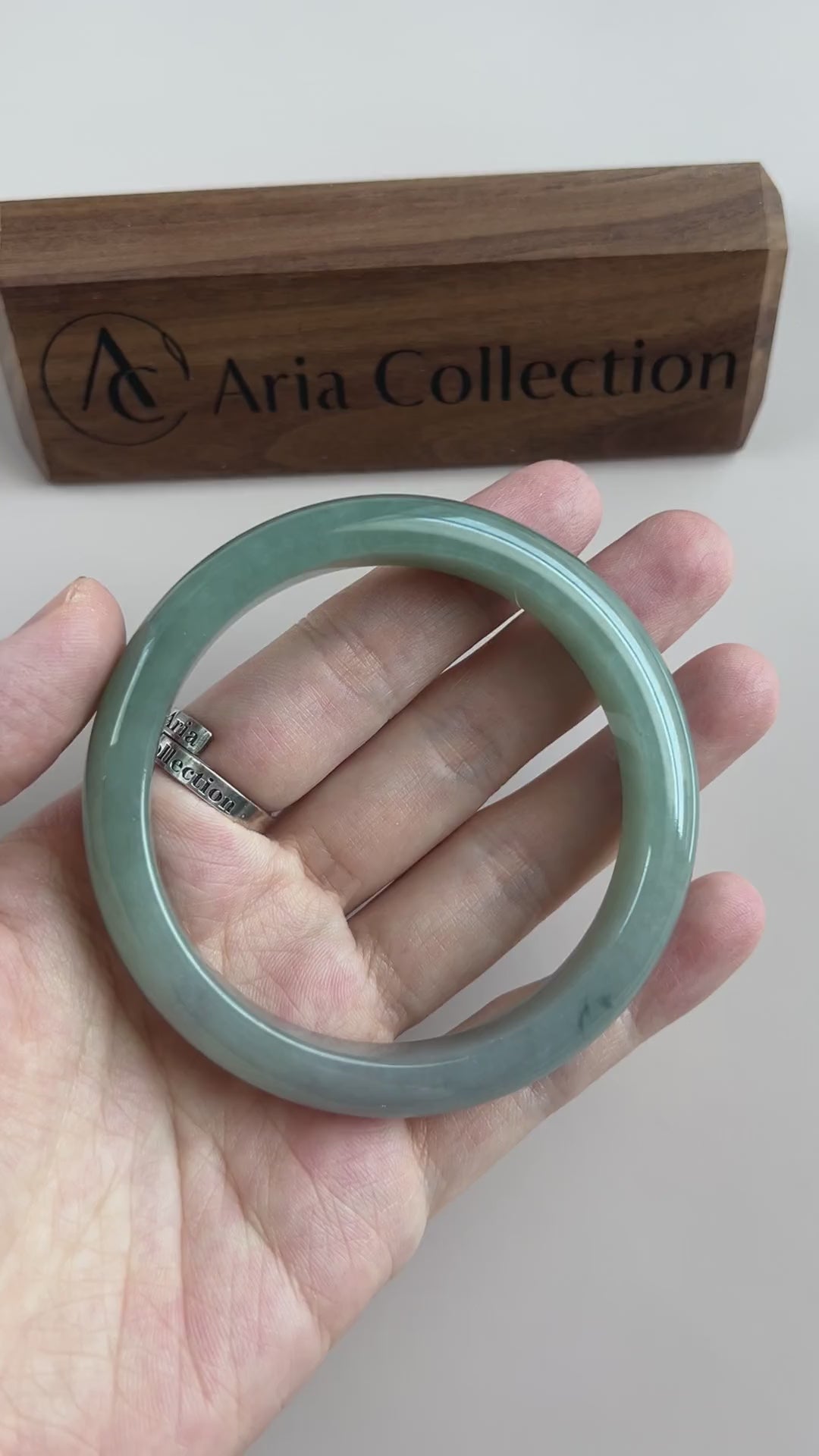 Video of a polished Burmese Type A jadeite bangle in soft light green-blue with a translucent, smooth classic form