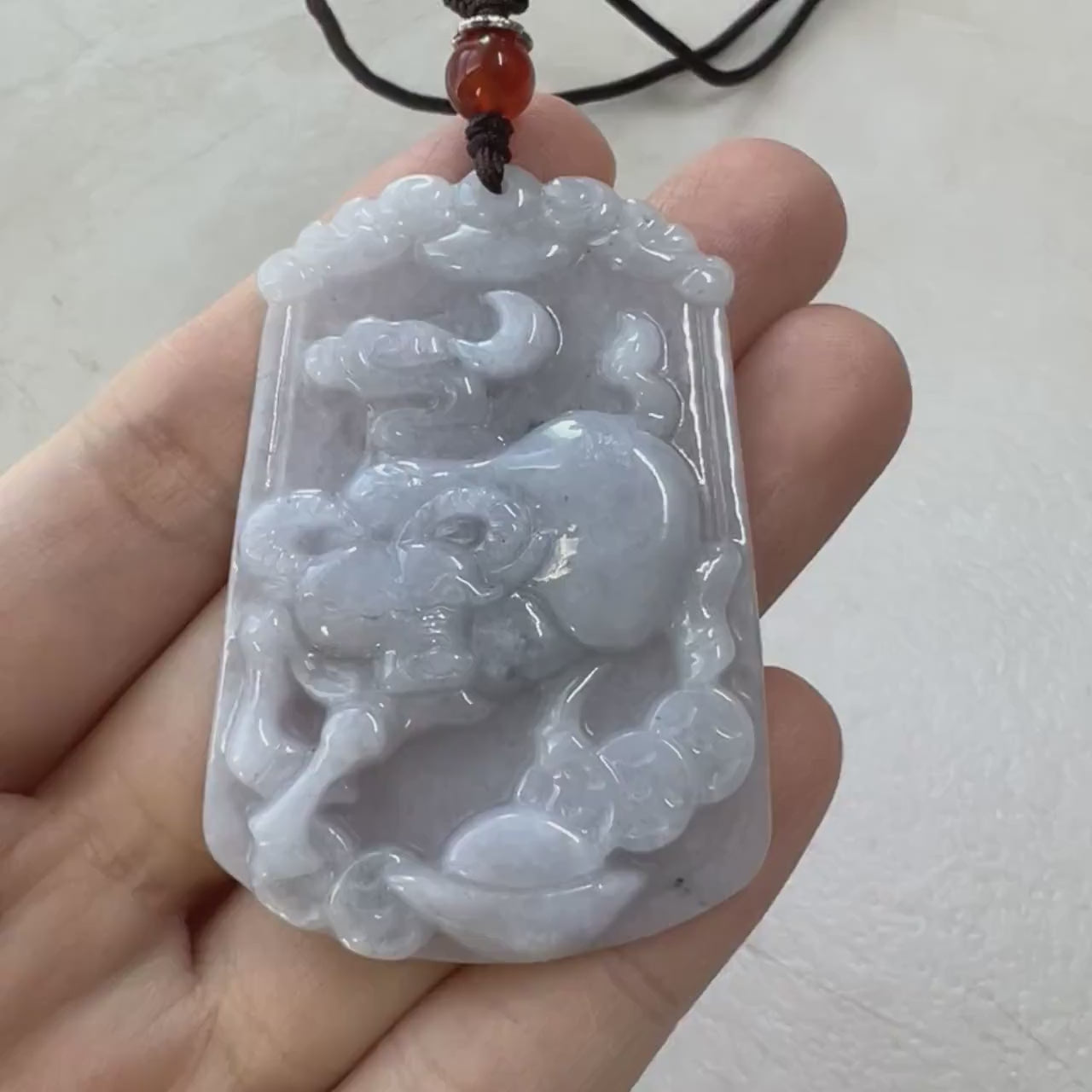 Video of an Ox pendant with ingot and Chinese coin motifs in a traditional gold prosperity design