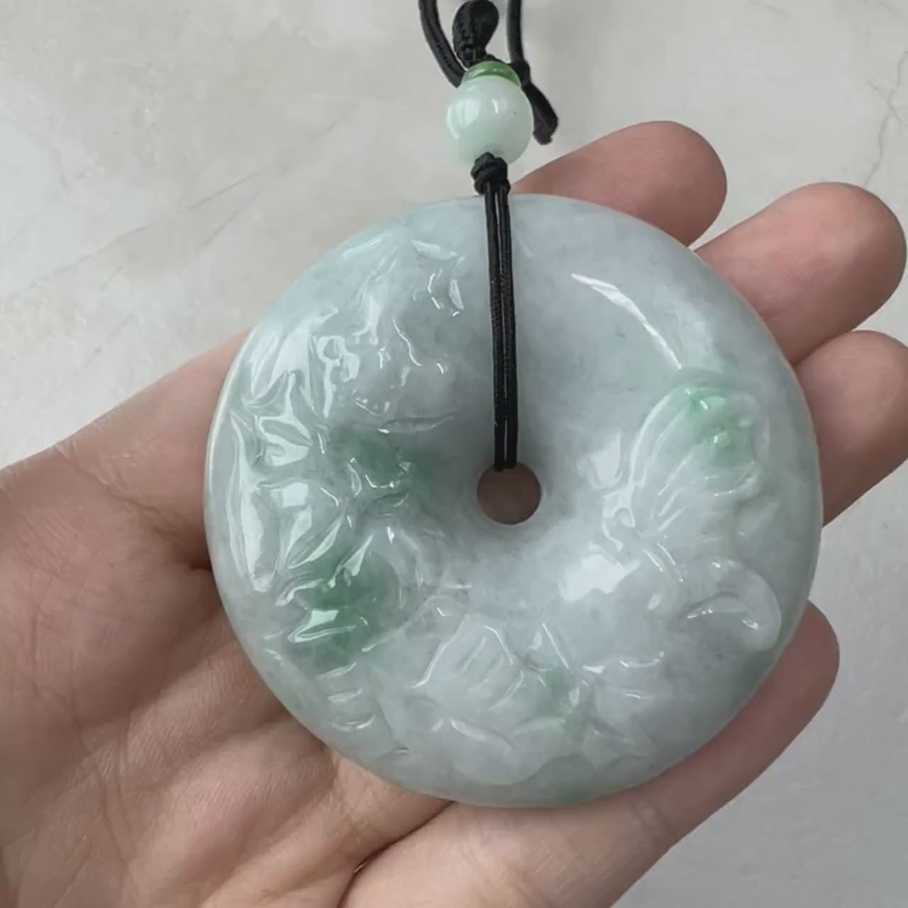 Video of antique-style hand-carved jade Peace Circle pendant with soft gray and vibrant green tones on a 24" beaded necklace
