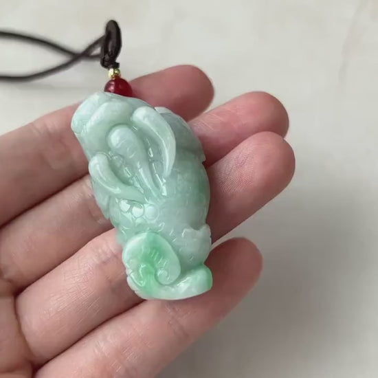Video of a richly green jadeite Pi Xiu pendant with a glowing translucent carved mythological animal design