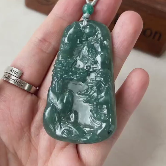 Video of a natural jadeite jade pendant with hand-carved mountain and river landscape, elegant green East Asian style
