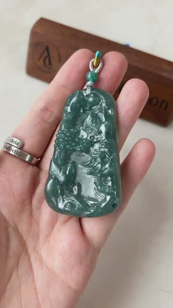 Video of a natural jadeite jade pendant with hand-carved mountain and river landscape, elegant green East Asian style