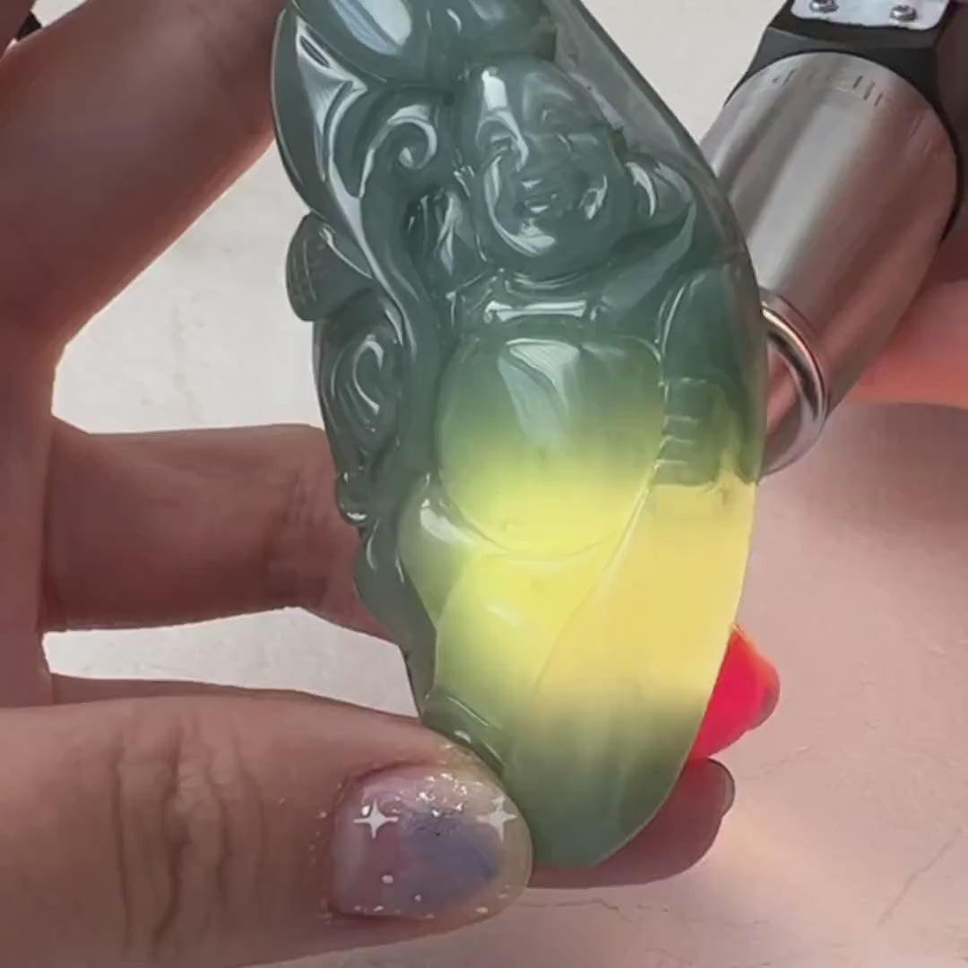 Video of a hand-carved blue-green jadeite Laughing Buddha pendant with ruyi detail and soft translucent glow